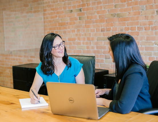 two people talking in a meeting room